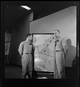 Two officers addressing an Air Force radar picket plane crash to reporters