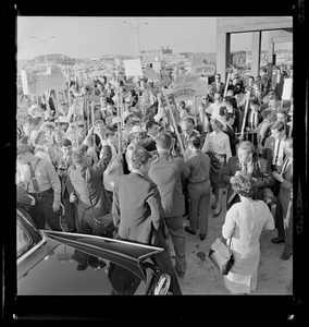 Senator Barry Goldwater walking through a crowd of people and reporters