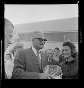 Senator Barry Goldwater holding a deflated football that reads "JFK in '54"