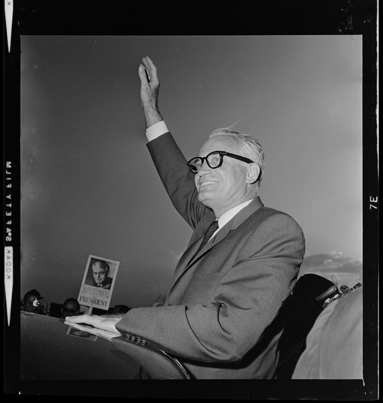 Sen. Barry Goldwater's waving from a car that carried him from Logan Airport to the Ritz Carlton Hotel