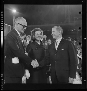 Sen. Barry Goldwater and Governor Volpe shake hands while Peggy Goldwater looks on