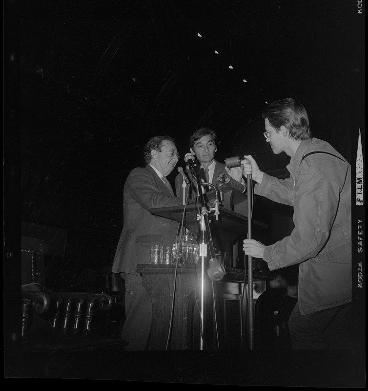 Men fixing the microphones for I.F. Stone