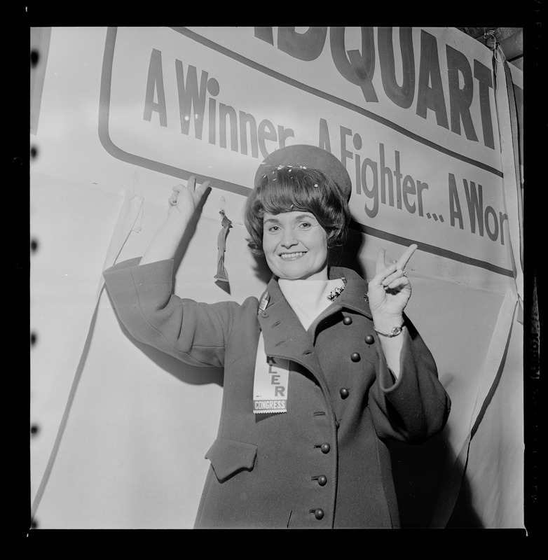 Margaret Heckler after election poses next to campaign headquarters signage