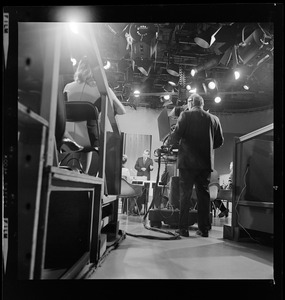 Backside of a camera man set up to record Richard Nixon in studio