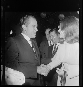 Richard Nixon shaking hands with a woman