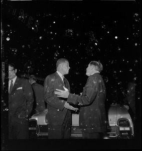 Sen. Edward Brooke and Governor Volpe talking in front of a vehicle