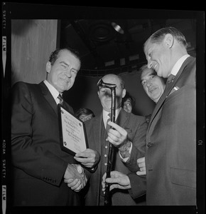 Man from the Irish Blackthorn Walking Stick Society giving Richard Nixon a certificate, walking stick, and hand shake
