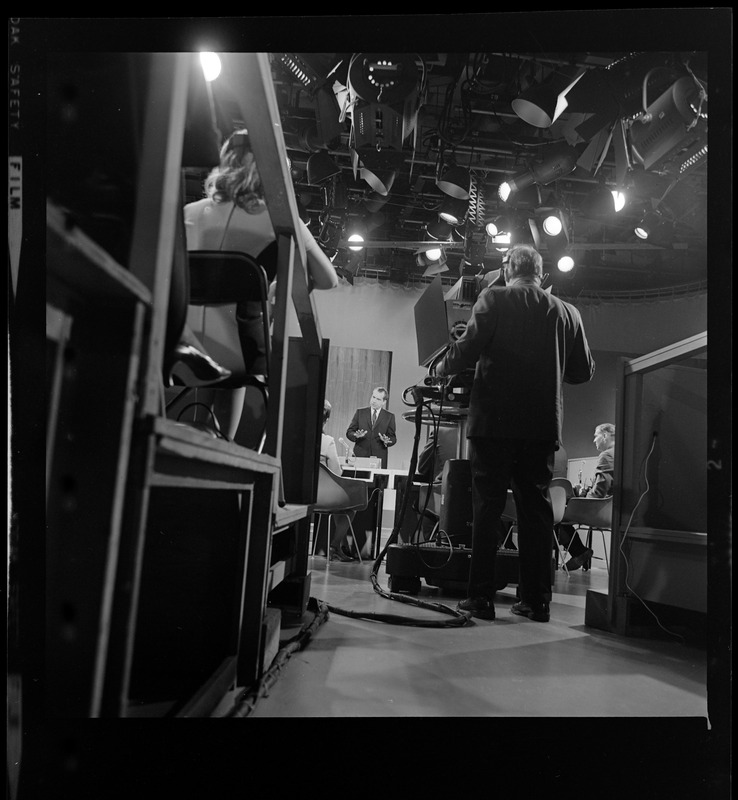 Backside of a camera man set up to record Richard Nixon in studio