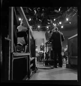 Backside of a camera man set up to record Richard Nixon in studio