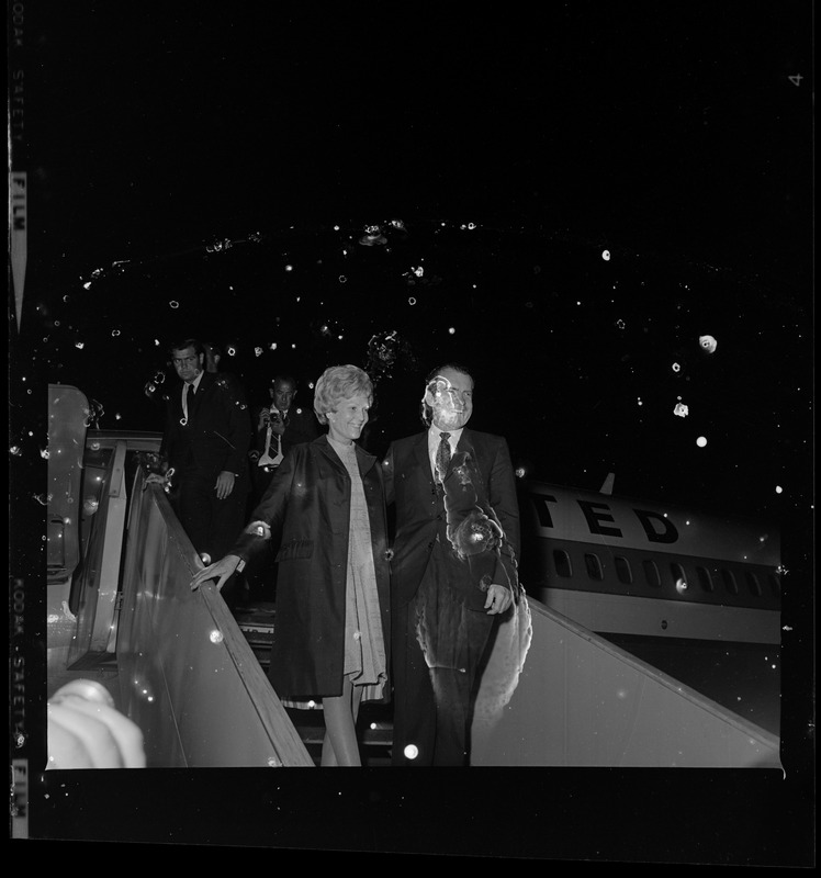 Mr. and Mrs. Nixon leaving a United flight after landing in Boston