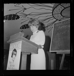 Margaret Heckler at the podium addressing the room