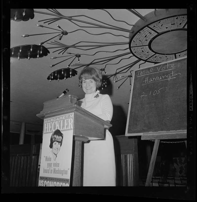 Margaret Heckler at the podium addressing the room