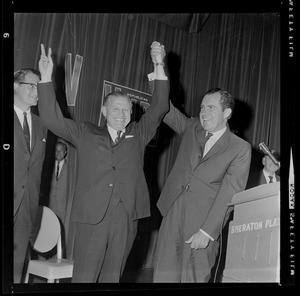 Republican candidate for Governor John A. Volpe, left, and former Vice President Richard M. Nixon salute supporters at the Sheraton Plaza Hotel with victory signs