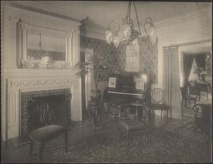 Unidentified interior, parlor with fireplace and piano
