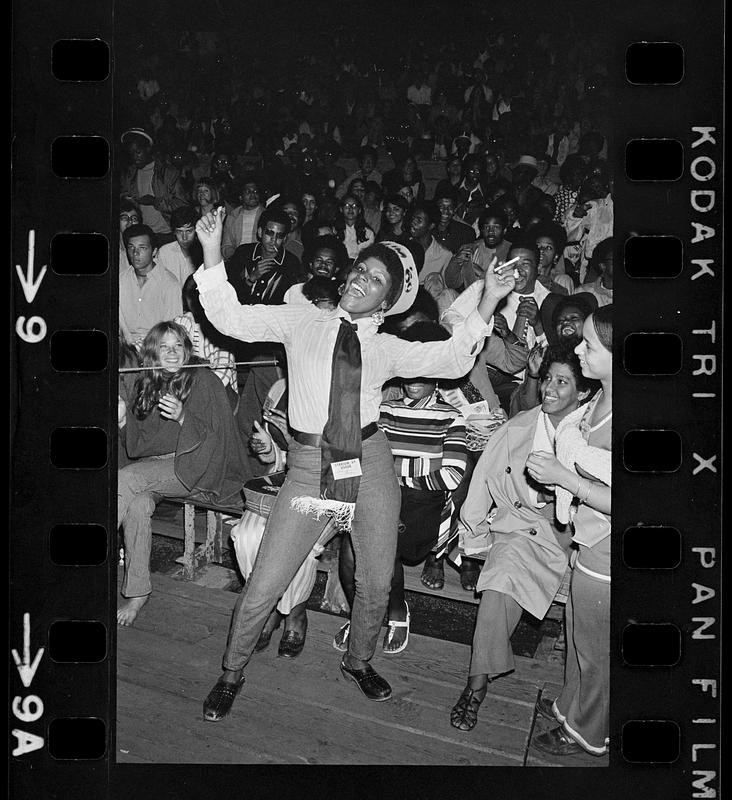 Exuberant usher at rock concert, Harvard Stadium