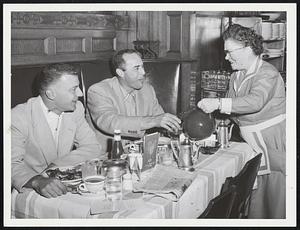 Joe DeMastri and Vic Raschi of the Athletics, get some advice along with their ice water from Kenmore waitress, Anna Mc Cluskey.