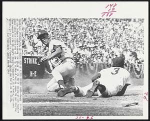 Los Angeles – First Run of Fifth Series Game – Maury Wills of the Dodgers skids across the plate in the first inning at Los Angeles today with the first run of the fifth World Series game. He was scoring from second on Jim Gilliam’s single. Teammate Willie Davies, the next batter, is in ground in foreground signaling for Wills to slide.