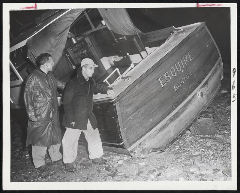 Washed Ashore In Storm Ollie Aldrich (left) and Ralph Lincoln look over the boat, "Esquire