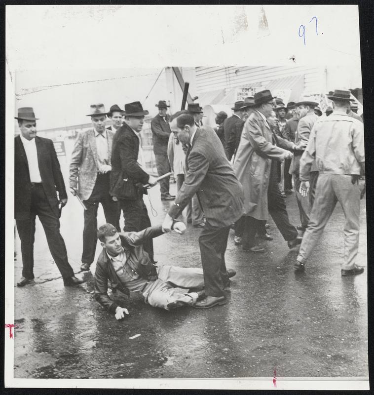 Battling pickets tangle with deputy sheriffs during strike at U.S. Pipe and Foundry Co. in Bessemer, Ala. in foreground deputy threatens subdues picket with club while others in background, Fight started when about 100 pickets attempted to keep supervisory personnel from work. Strike has been in effect since November.