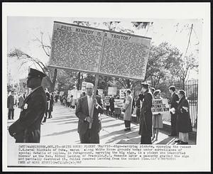 White House Picket Traffic--Sign-carrying pickets, opposing the recent U.S. naval blockade of Cuba, march along White House grounds today under surveillance of special details of police. In foreground, carrying the big sign, is a picket who identified himself as the Rev. Sidney Lansing of Franklin, N.J. Moments later a passerby grabbed the sign and partially destroyed it. Police removed Lansing from the picket line.