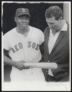 Red Sox rookie sensation George Scott talks with Ted Williams before start of last night's Jimmy Fund exhibition game against the Atlanta Braves at Fenway park. Hose won, 5-3.
