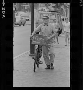 Bill Plante, Sr. pushing bicycle