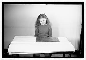 A girl matching fitting shapes in a puzzle