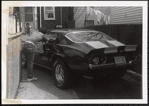 Person reaching into a car