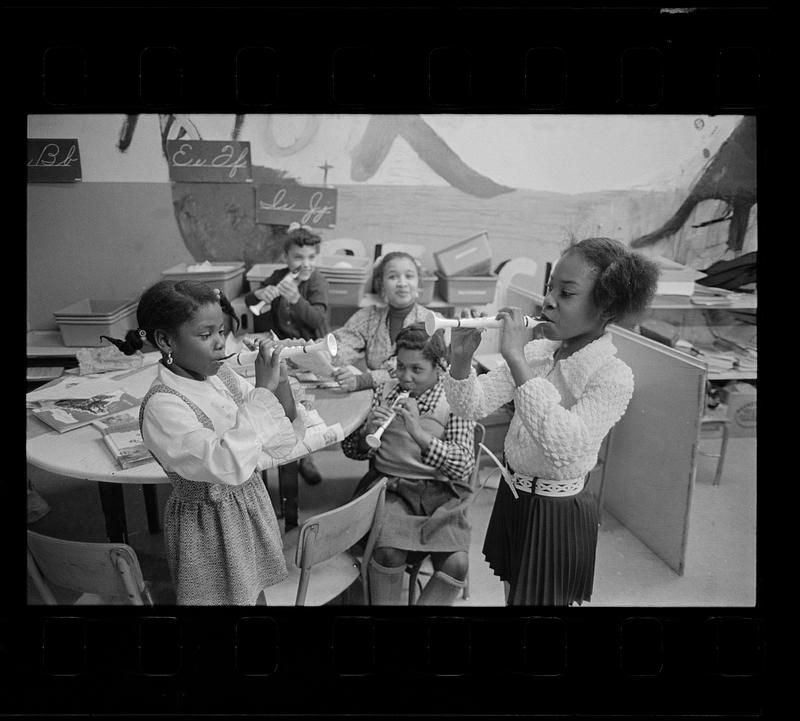 Black schoolchildren play recorders, Roxbury