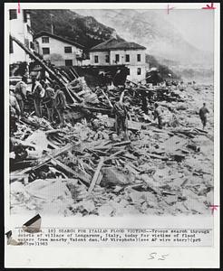 Search for Italian Flood Victims--Troops searched through debris of village of Longarone, Italy, today for victims of flood waters from nearby Vaiont dam.