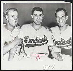 Wilmer (Vinegar Bend) Mizell of the St. Louis Cardinals is the happy young man in the center after he pitched a four-hit win over the New York Giants. the Cards now lead the National League in won-and-lost, but trail Milwaukee in percentage points. Flanking Mizell are homer-hitters Rip Repulsi (left) and Bill Sami. Repulsi hit his sixth of the season, while it was Sarni's third.