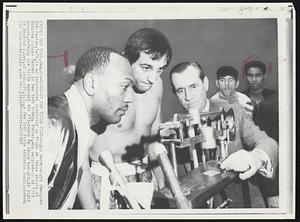 Weigh-In for Title Tilt-Light Heavyweight Champion Bob Foster, left, is an interested spectator as Frank De Paula weights at Madison Square Garden in New York today. Foster, who weighed-in at 171 1/2 pounds, defends his title against the 173-pound De Paula tonight. At right is Raymon J. Lee, of Lockport, N.Y., a New York State Athletic Commissioner.