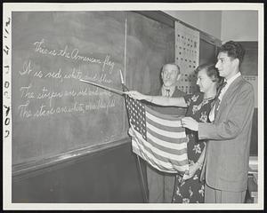Temple Kehillath. A study of the flag. L to R. Samuel Beck, 66 yrs old. Miss Augusta H. Bergson, Teacher, Heinrich Spasleng, 21 yrs. School for New Comers DP’s.