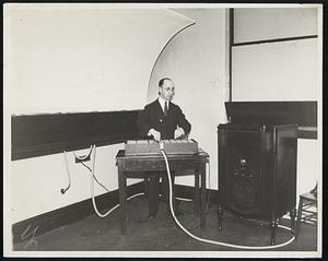 "Perfumed movies" For Cure Are Insane. Experiments in the use of music, colors and various perfumes in the treatment of mental cases at the Chicago State hospital for the insane or being conducted by Walter Spilkey, psychologist. The new equipment, different to the hospital by Samuel Insull, the Chicago utilities magnate, is known as the "colorama" and throws up on a screen in a darkened room a weaving of colored lights, all of which are the sign to supplement the effect of the music and scents. The new treatment is said to prove very beneficial in certain forms of insanity, especially "selected cases of melancholia and chronic depression." Photo-shows Walter Spilkey, psychologist, operating the new "colorama" with reflecting screen at left.