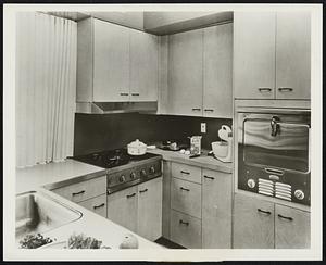 Kitchen of 1953 “House of Ideas” How built-in gas cooking units save space and give uncluttered look to a compact kitchen is shown in 1953 “House of Ideas,” Winnetka, Ill., created by House & Garden magazine. Cooking units are Chambers stainless steel In-a-Top four burner and In-a-Wall oven making possible convenient, waist-high cooking.