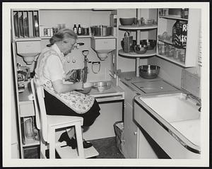 Kitchen Work Made Easier. Model kitchen for minimum housework exhibited by the New York Heart Association at the Museum of Natural History in New York. Dr. Lillian M. Gilbreth, consulting engineer and chairman of the association’s committee which planned a “work simplification” kitchen, demonstrates one way to take it easy. Seated in the kitchen’s “baking corner” – a work counter 32 inches high – she shows that a lower work surface is more comfortable when long-handled utensils are being used. The sink, high and low work counters, supplies and ice box are all within easy reach.