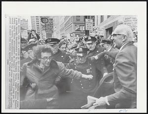 Action on the Peace Front- Boston police clear a path through demonstrators as Dr. Benjamin Spock, right, leaves Federal Court today after arraignment on charges of counseling young men to avoid the draft. Demonstrators were from groups supporting and opposing stand of famed baby doctor against Vietnam war.