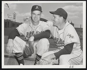 Ex-National League Stars who played opposite each other now teammates in the American League. Johnny Sain (left), who pitched the Boston Braves to the 1948 National League pennant, and Enos Slaughter, a great player with the St. Louis Cardinals, seems to approve of their new surroundings, the Kansas City Athletics.