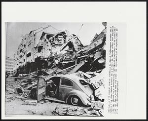 Skopje Street Scene -- A battered Volkswagen stands amid rubble from demolished houses on a street in Skopje after the Yugoslav city was struck by a devastating earthquake yesterday. City officials fear the death toll may run into the thousands.