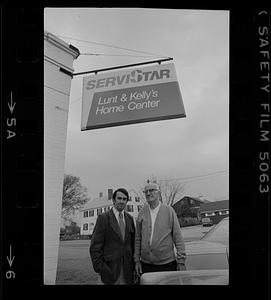 Peter and Edward Kelly under sign for Lunt & Kelly's Home Center