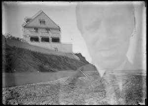 Double exposure: person's face, house on hill - not known