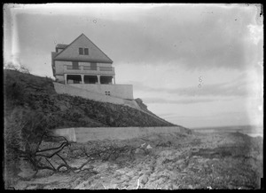 House on water - more land on opp. shore visible. Unidentified