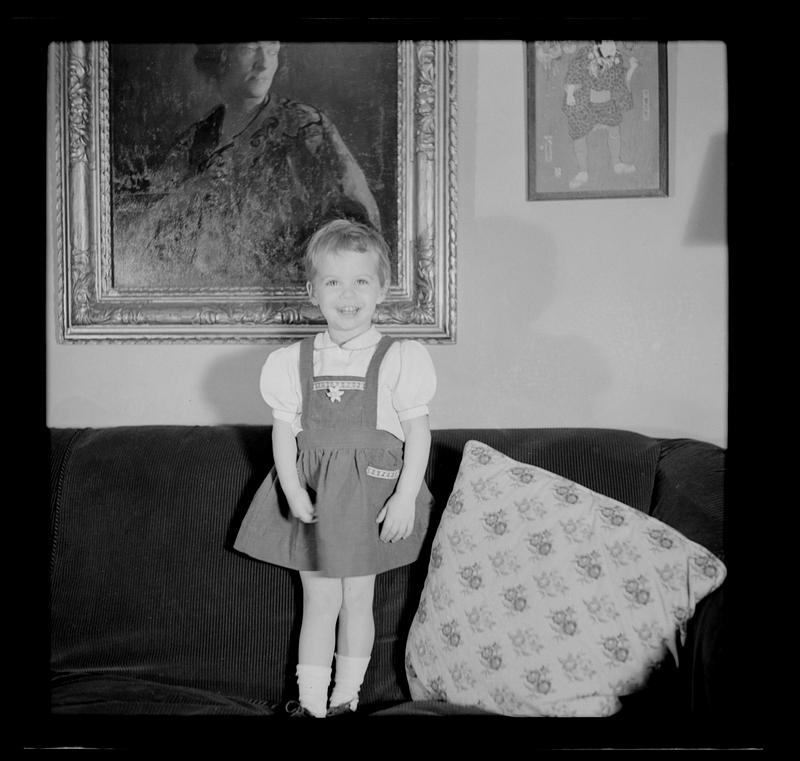 Young girl standing on sofa