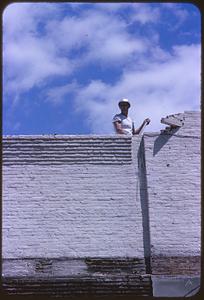 Construction worker standing on roof