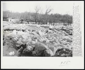 River Ice Jam Threatens Houses--A four mile ice jam on the Fox River has caused flood conditions north of here and threatens these houses at Dayton today. Many families have been forced to leave their homes in this area southwest of Chicago. Officials said it appeared that only thawing weather would break the jam which has raised the river 24 feet above flood level.