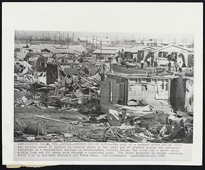 Wichita Falls, Tex. - Crushed Row Of Homes - The path of a tornado which killed seven and injured about 50 persons is clearly shown in the contrast of crushed houses and untouched buildings in a residential section in southwestern Wichita Falls. The cloud cut a swath about a mile long and 500 yards wide through a populated area. The storm occurred in bright sunshine about 3 pm in and near Sheppard Air Force Base.