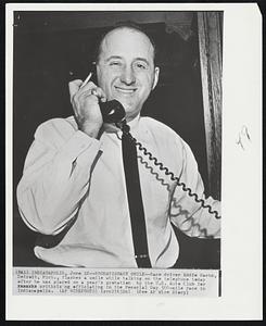 Probationary Smile-- Race driver Eddie Sachs, Detroit, Mich., flashes a smile while taking on the telephone today after he was places on a year's probation by the U.S. Auto Club for criticizing officiating in the Memorial Day 500-mile race in Indianapolis.