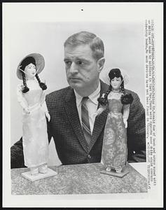 Police Lt.Ronald Rae of bomb and arson squad with two dolls sent home by soldiers in Viet Nam.There were reports some dolls might contain booby-trip bombs.No such devices have yet been found in Chicago.