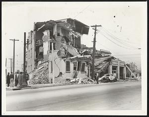 Quake Razes Long Beach Bakery. Twisted and shattered by the Open Air School Sessions After Quake. For the first time since the California earthquake, Long Beach's 30,000 school children returned to classes April 3, meeting on school grounds, athletic fields, in park and other places. A long Beach High School Class is shown here resuming studies. A plan of homework assignments, aided by newspapers and radio is in effect temporarily until repairs are completed on school buildings which survived the earthquake. Officials estimated two thirds of the structures in the $12,000,000 school system will have to be razed. of March 10, this building in long beach, Calif., occupied by a baking company, was one of the many structures demolished.