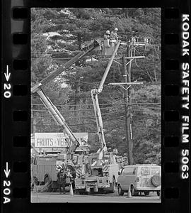 Electric company tending wires
